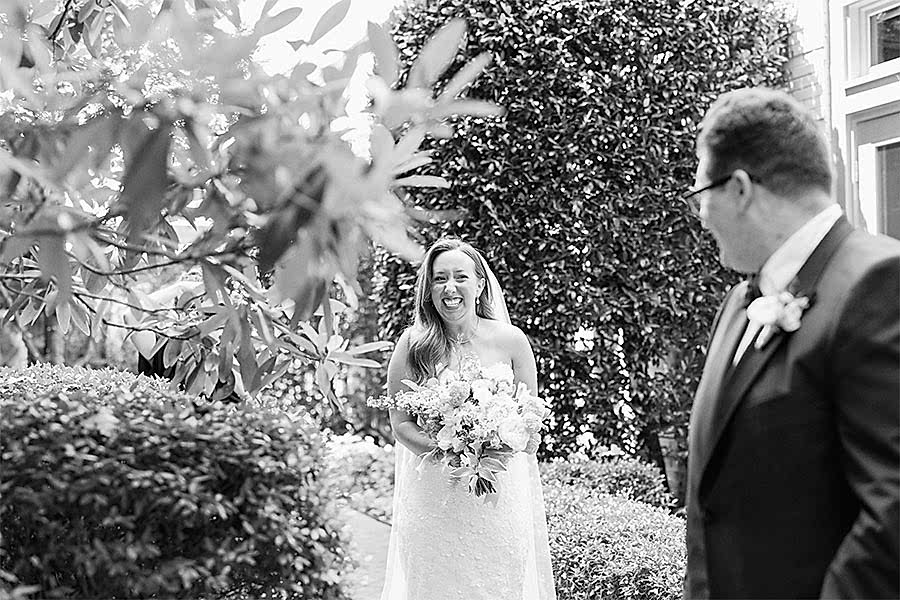Bride and groom sharing a first look in the Bluebell Garden at Proximity Hotel in Greensboro, North Carolina
