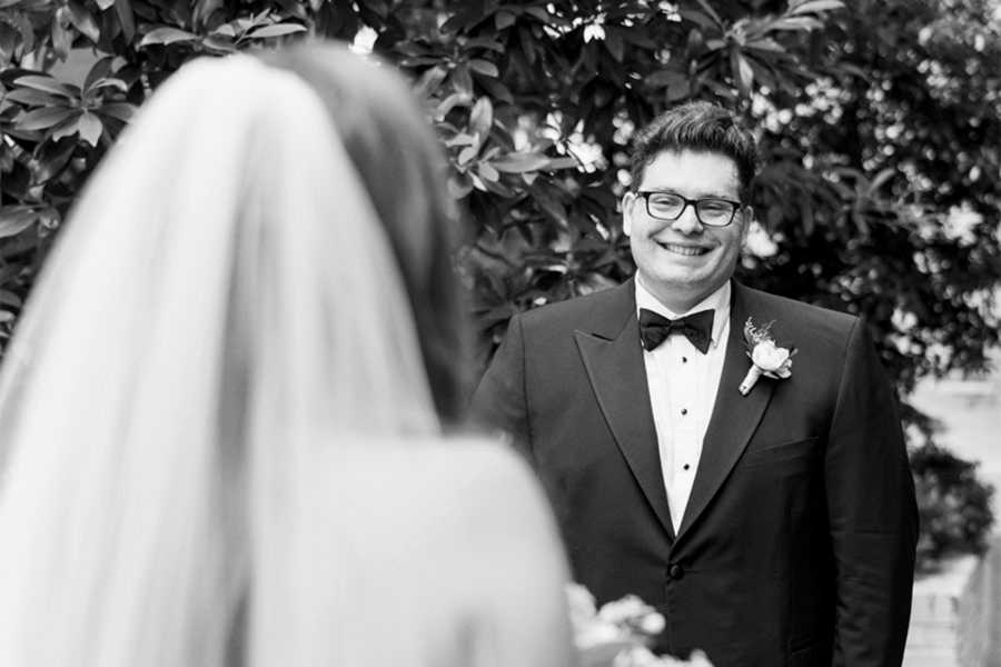 Bride and groom sharing a first look in the Bluebell Garden at Proximity Hotel in Greensboro, North Carolina