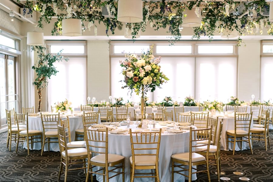 Wedding reception in the Weaver Room at Proximity Hotel featuring a live band, custom dance floor, and floral design