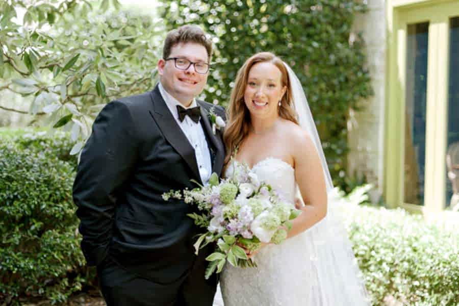 Bride and Groom posing in the bluebell garden