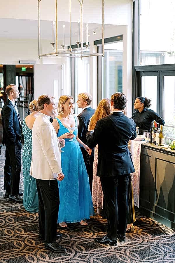 Guests stand in line and socialize in the weaver breezeway bar area.