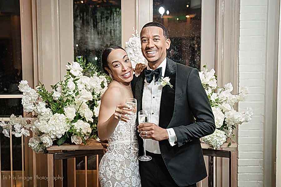 Bride and Groom smiling as they toast to each other at their elegant black tie wedding reception in the Weaver Room.
